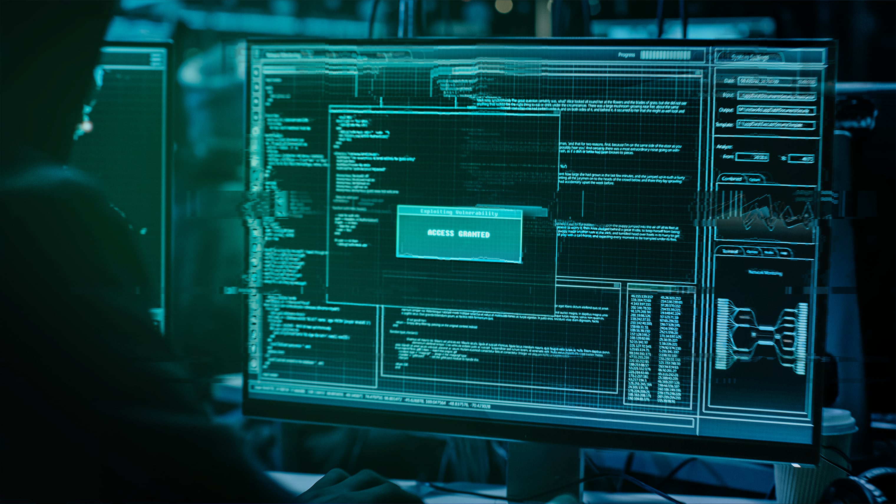 huntress-header-image Hacker looking at a computer screen